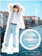 小林千晃のデビュー10周年記念写真集「Chiamore」のアクリルスタンドA。ヴェネツィアのような水辺の街並みを背景に、爽やかな服装の小林千晃がデザインされています。